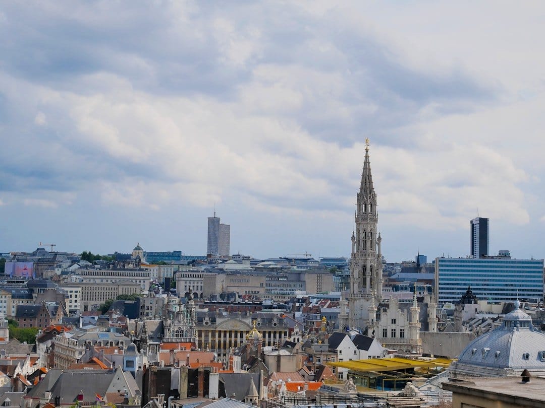 Geoffrey Hinton speaking at a conference, emphasizing AI risks in Europe, with an audience engaged in discussion.