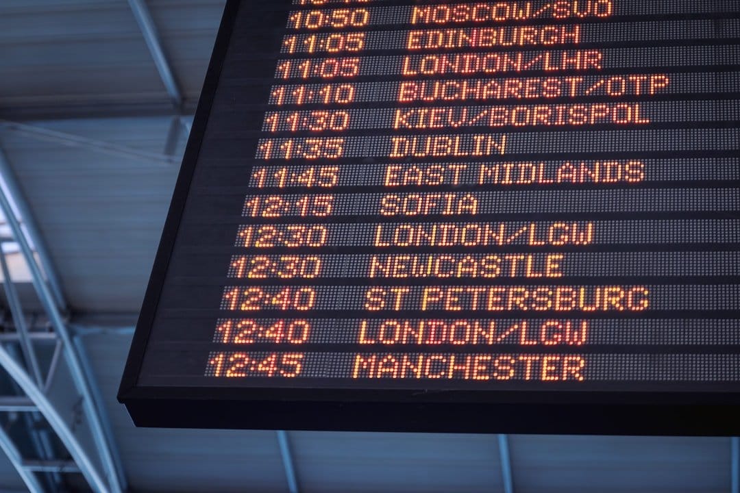 Airline staff managing flight schedules at an airport, highlighting the impact of fuel shortages on travel.