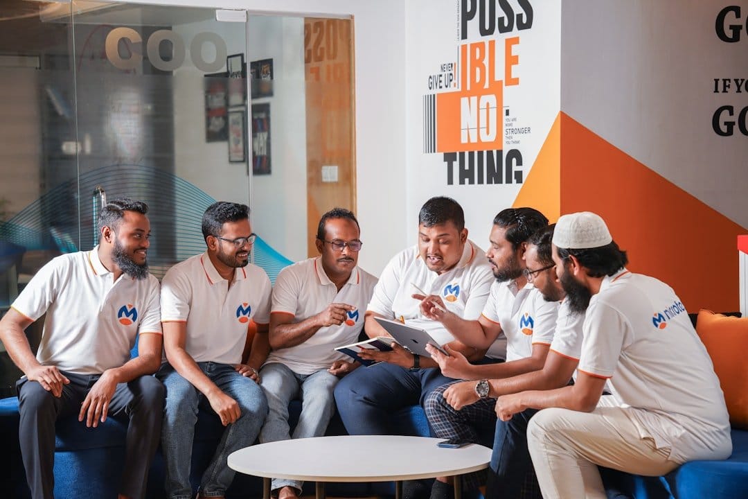 A group of diverse startup founders discussing challenges posed by the EU AI Act in a modern office setting.