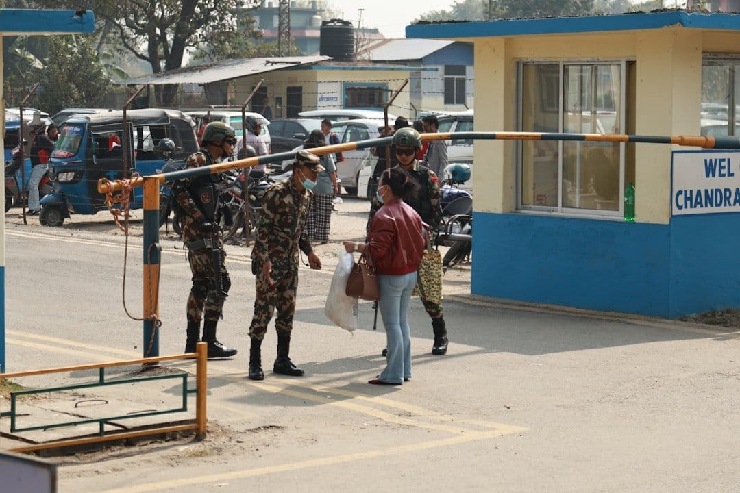 A traveler at a European border checkpoint, highlighting technology and security concerns related to ETIAS delays.