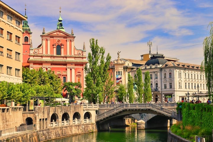 A vibrant European cityscape showcasing modern architecture and historic buildings, symbolizing innovation and cultural heritage.