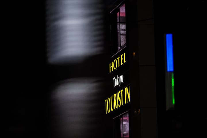 A smartphone displaying Google Hotel Price Alerts, showcasing last-minute hotel deals and travel planning options.