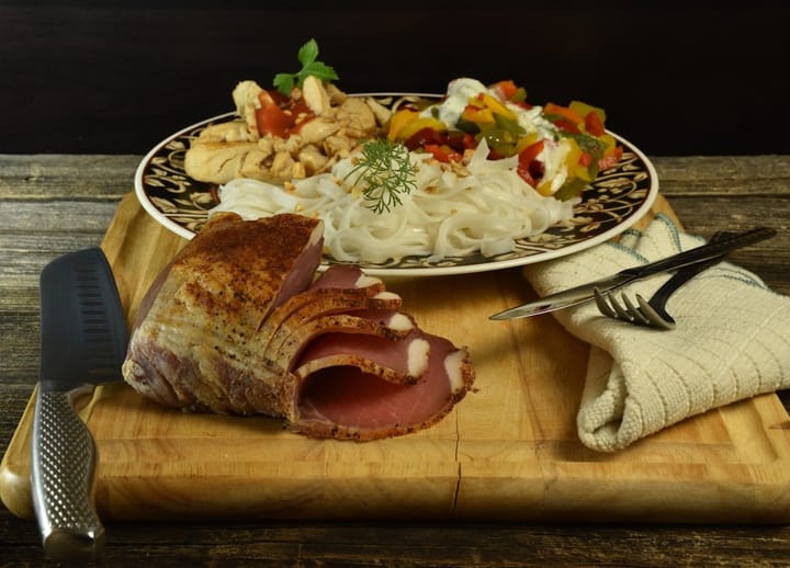 A beautifully glazed spiral ham garnished with herbs, ready for serving on a festive table.