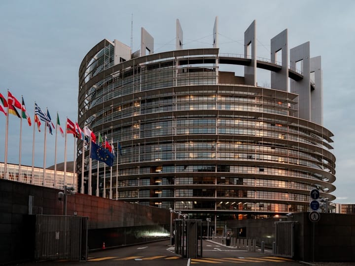 A group of policymakers discussing regulations on high-risk AI technologies in a European conference setting.