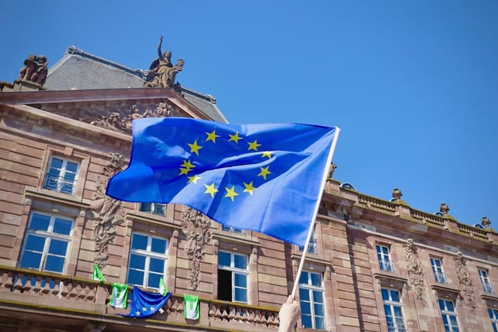 EU officials in a meeting room discussing the AI Act, highlighting lobbying influence on policy decisions.