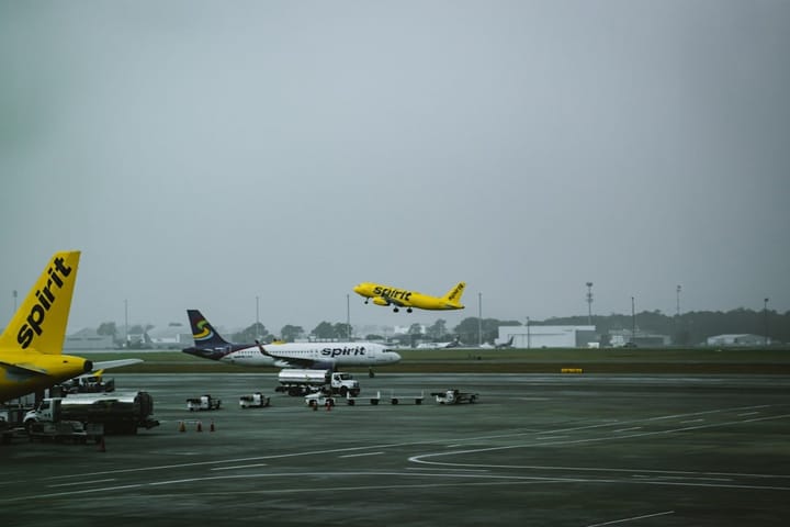 A Spirit Airlines plane parked at an airport, highlighting budget travel changes in the US airline industry.