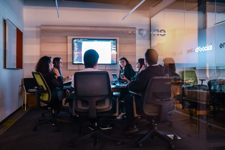 Katie Haun speaking at a conference, surrounded by digital currency graphics, symbolizing her leadership in crypto venture capital.