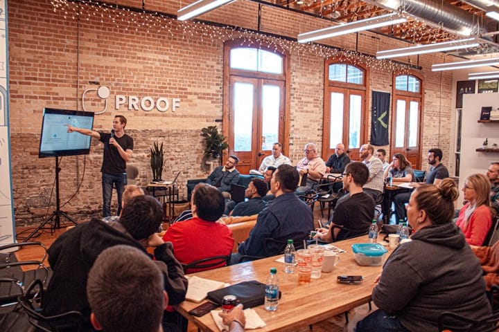 A diverse group of investors discussing venture capital strategies at a conference, highlighting trends in the Benchmark Growth Fund.