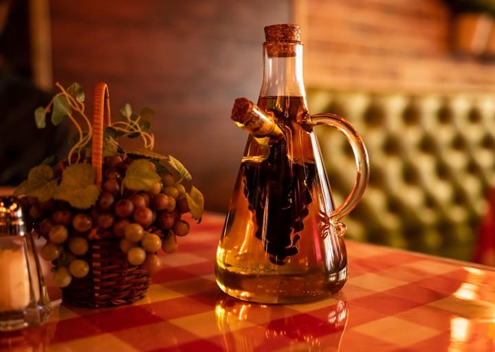 A close-up of olive oil bottles on a wooden table, highlighting the quality and authenticity of Italian olive oil.