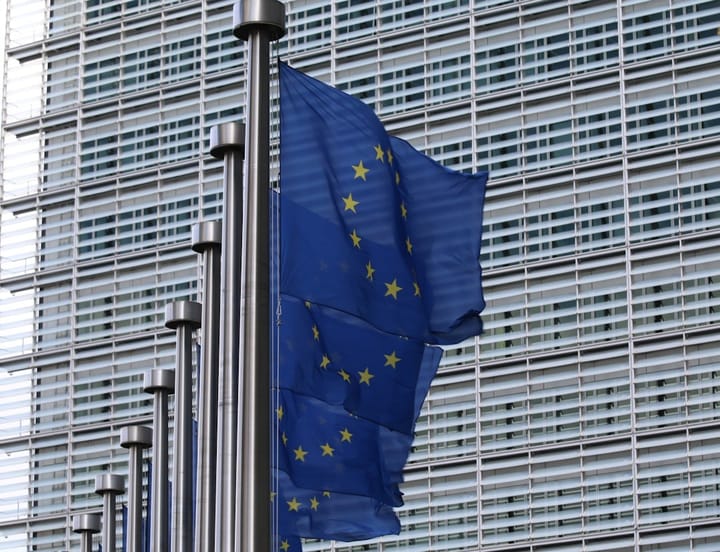 A group of EU advisers discussing AI regulations, with charts and graphs illustrating potential impacts on Europe.